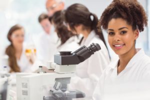 Science student looking through microscope in the lab