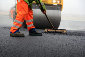 Roadworker laying tarmac